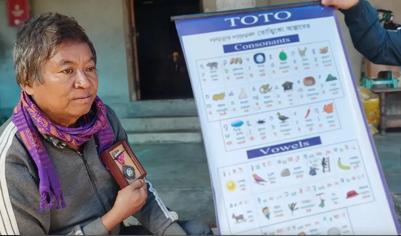 Dhaniram Toto with his Padma Shri award which he received for his efforts to develop the Toto script.