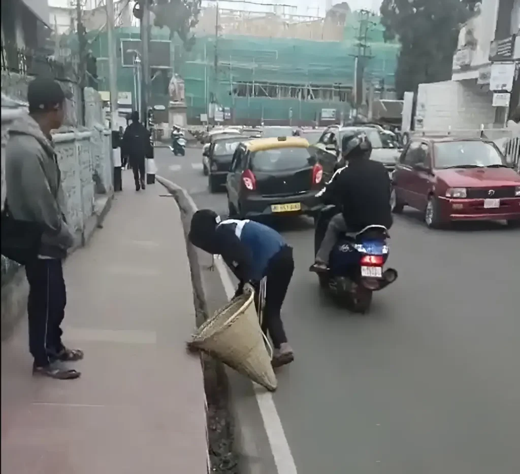 A person sweeping the street in shillong